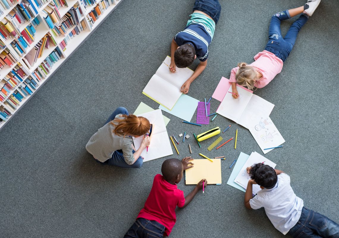 children coloring in a circle on the floor